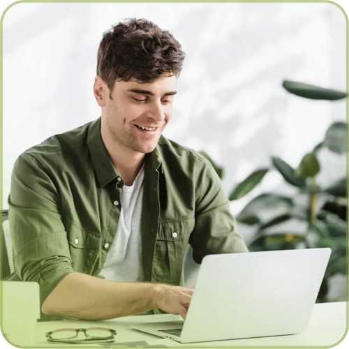 Man on computer in office smiling